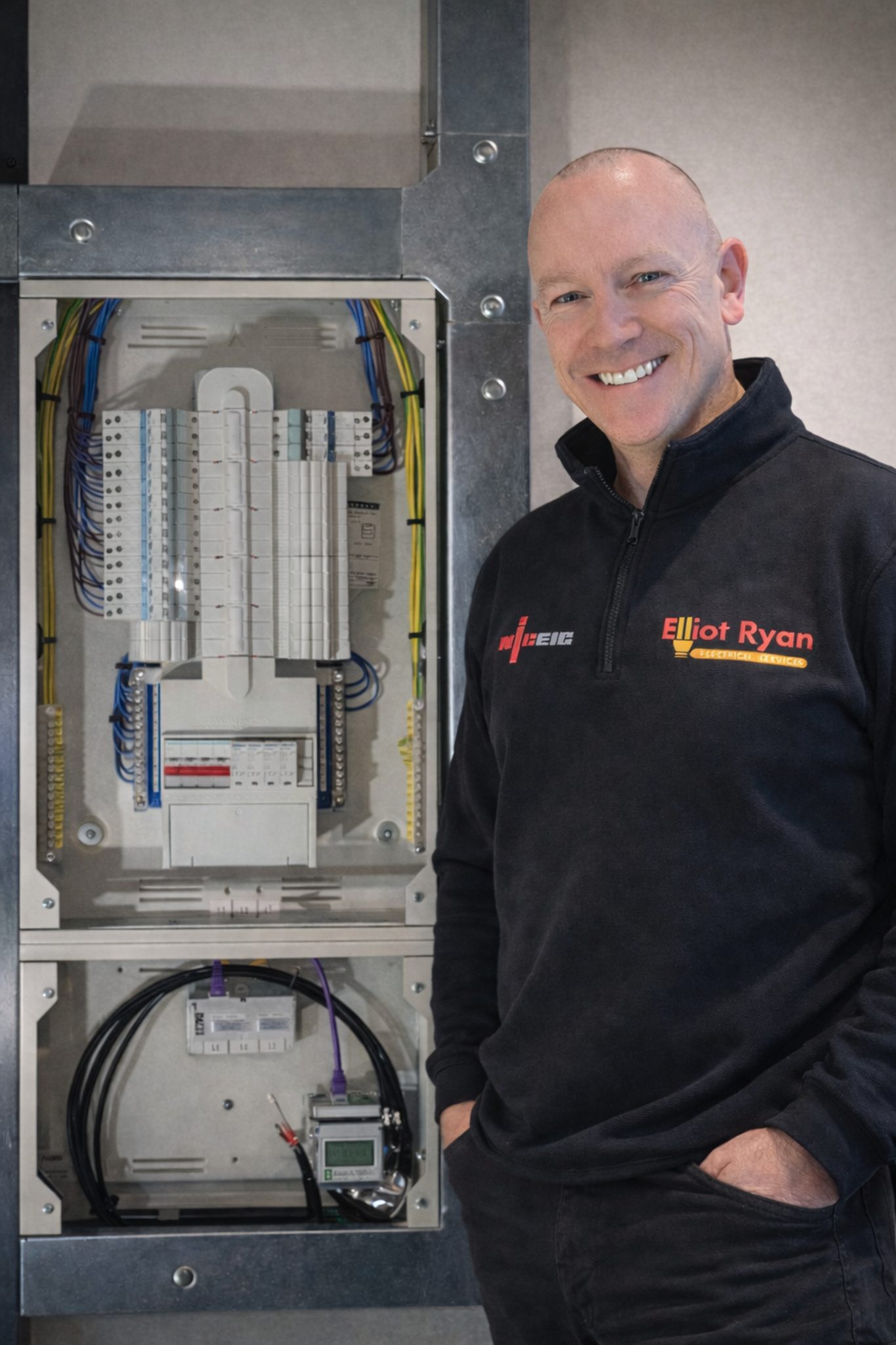 Elliot Ryan beside a distribution board and containment
